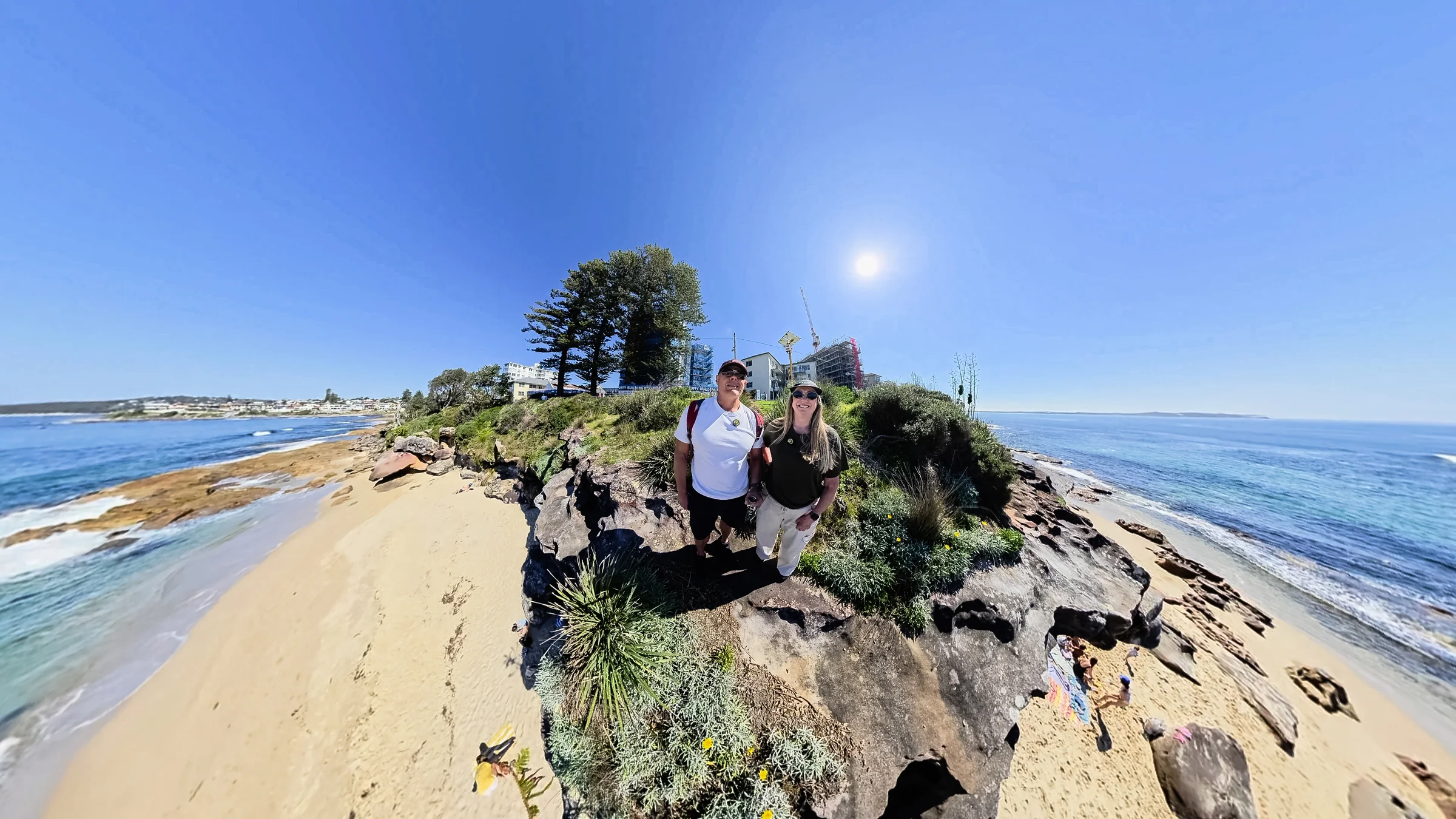Wide tiny-planet photograph of Rob and Sue with Blackwoods Beach and the coast around them