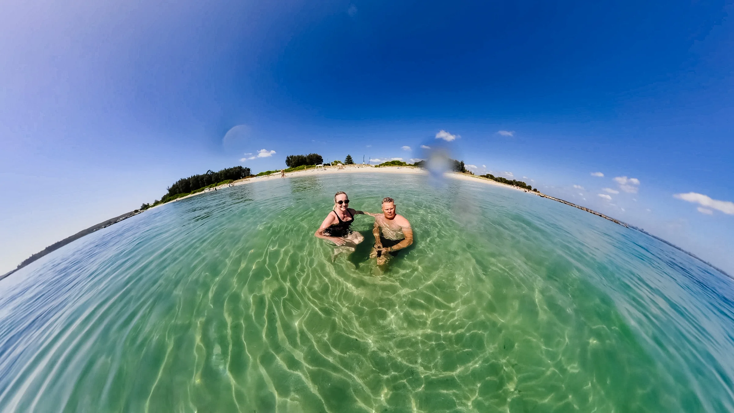 Rob and Sue swimming together in clear green water