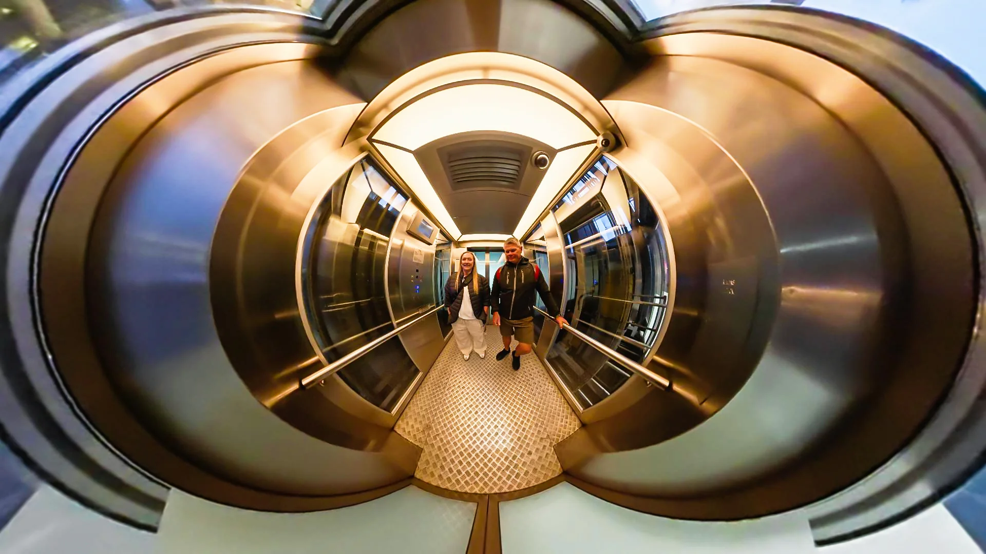 Curved 360-camera view inside a lift with metallic walls