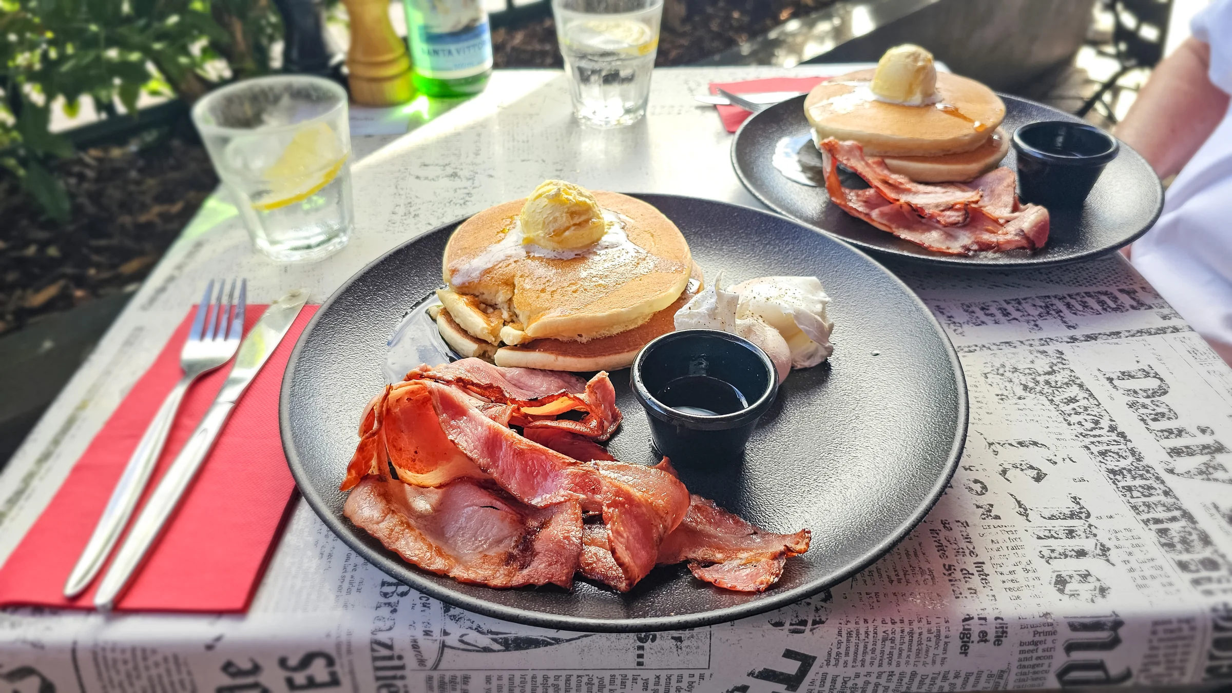 Pancakes, bacon and eggs on the table at City Extra