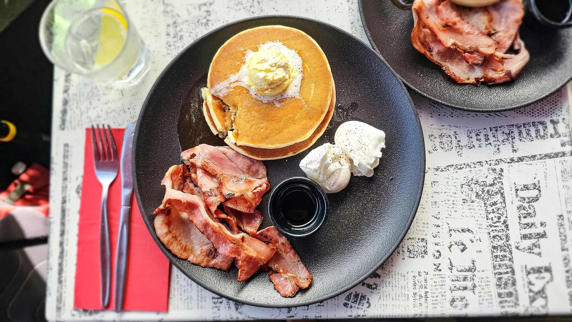 Closer view of pancakes, bacon and eggs on a City Extra plate