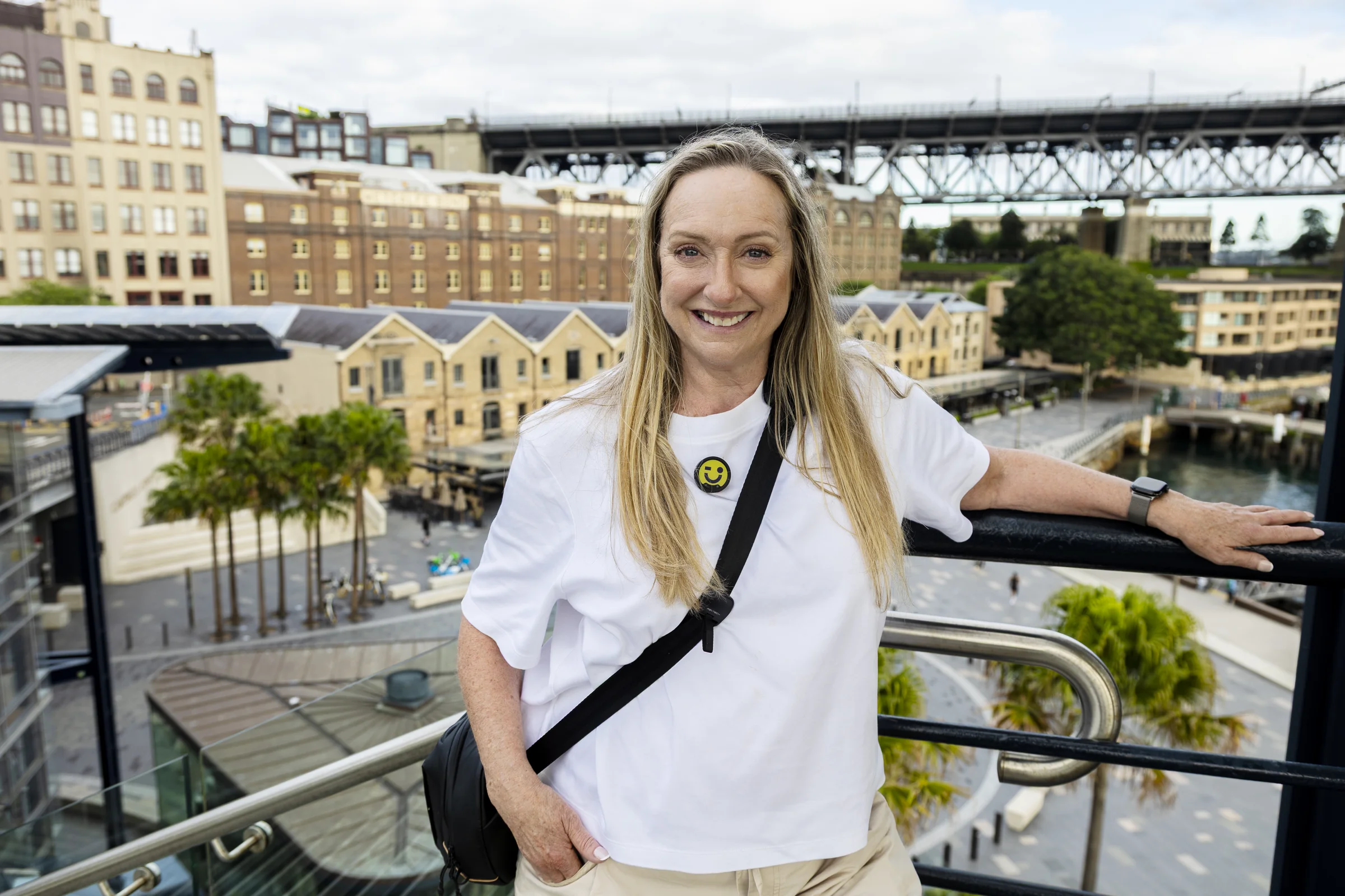 Sue at the Overseas Passenger Terminal rotunda with Campbells Cove and the bridge behind her