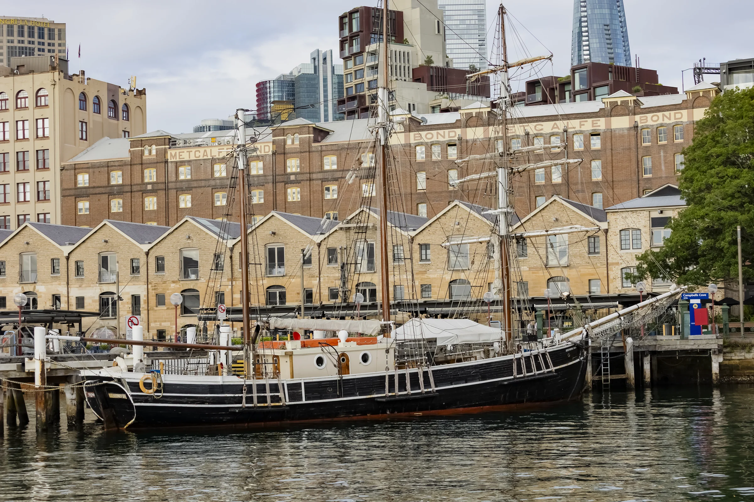 Tall ship moored beside the historic waterfront buildings at Campbells Cove