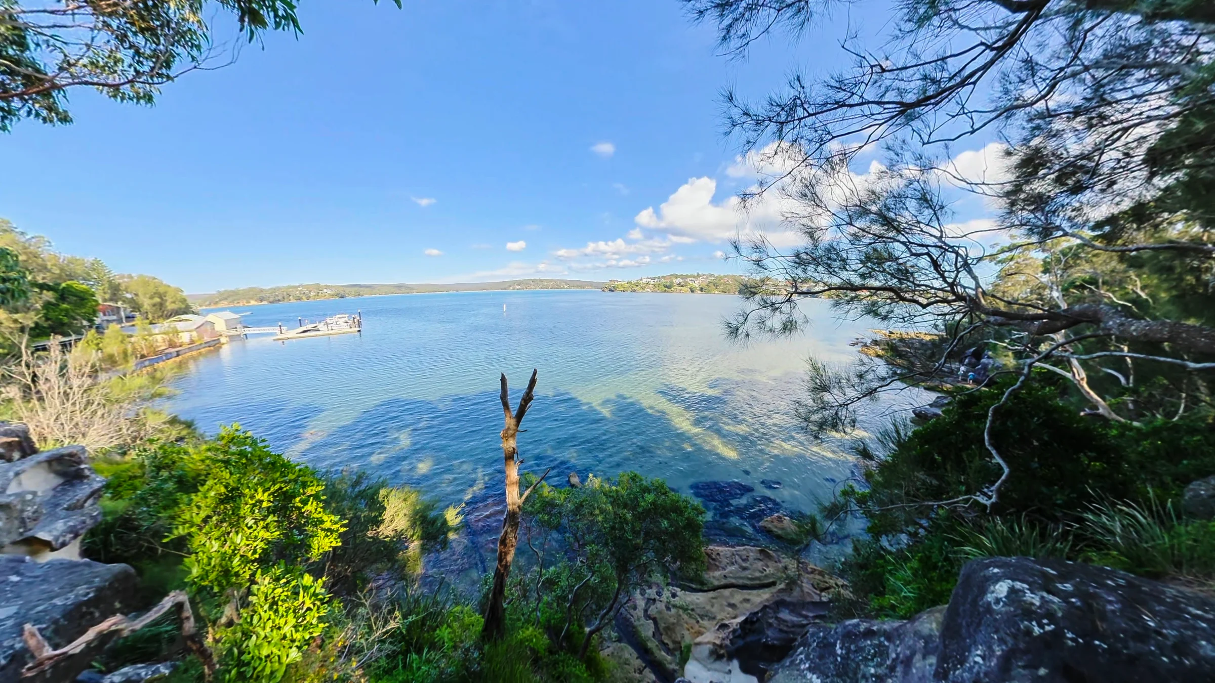 A view across the bay framed by rocks and bush at Darook Park