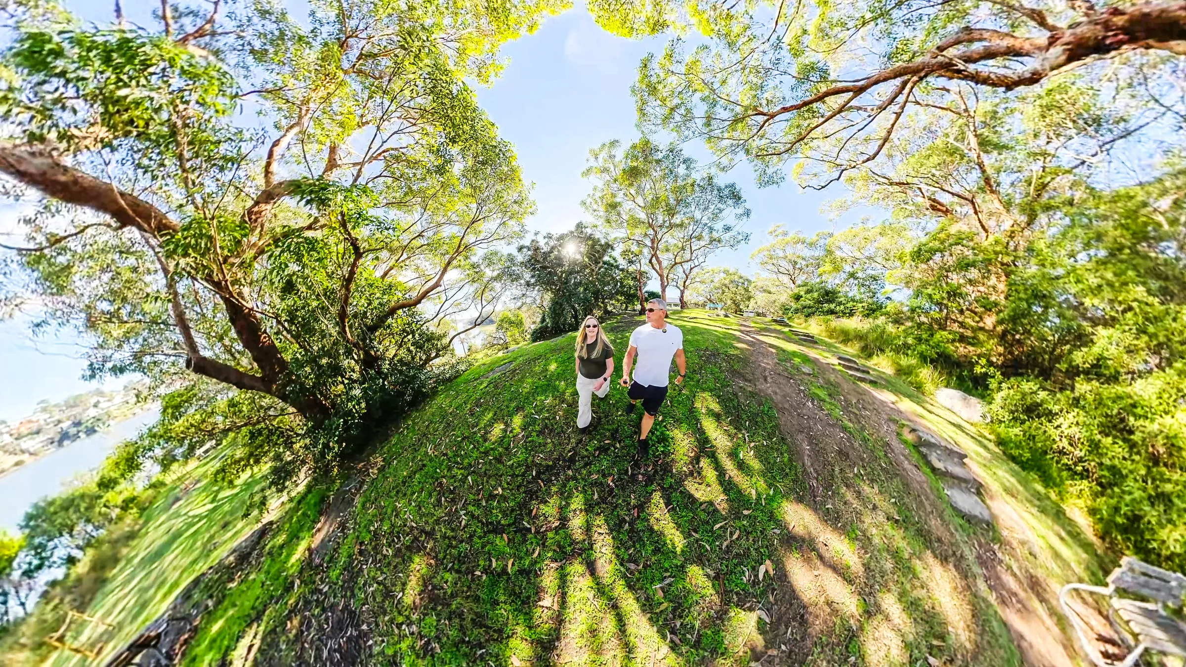 Rob and Sue beneath the trees in a tiny-planet photograph at Darook Park