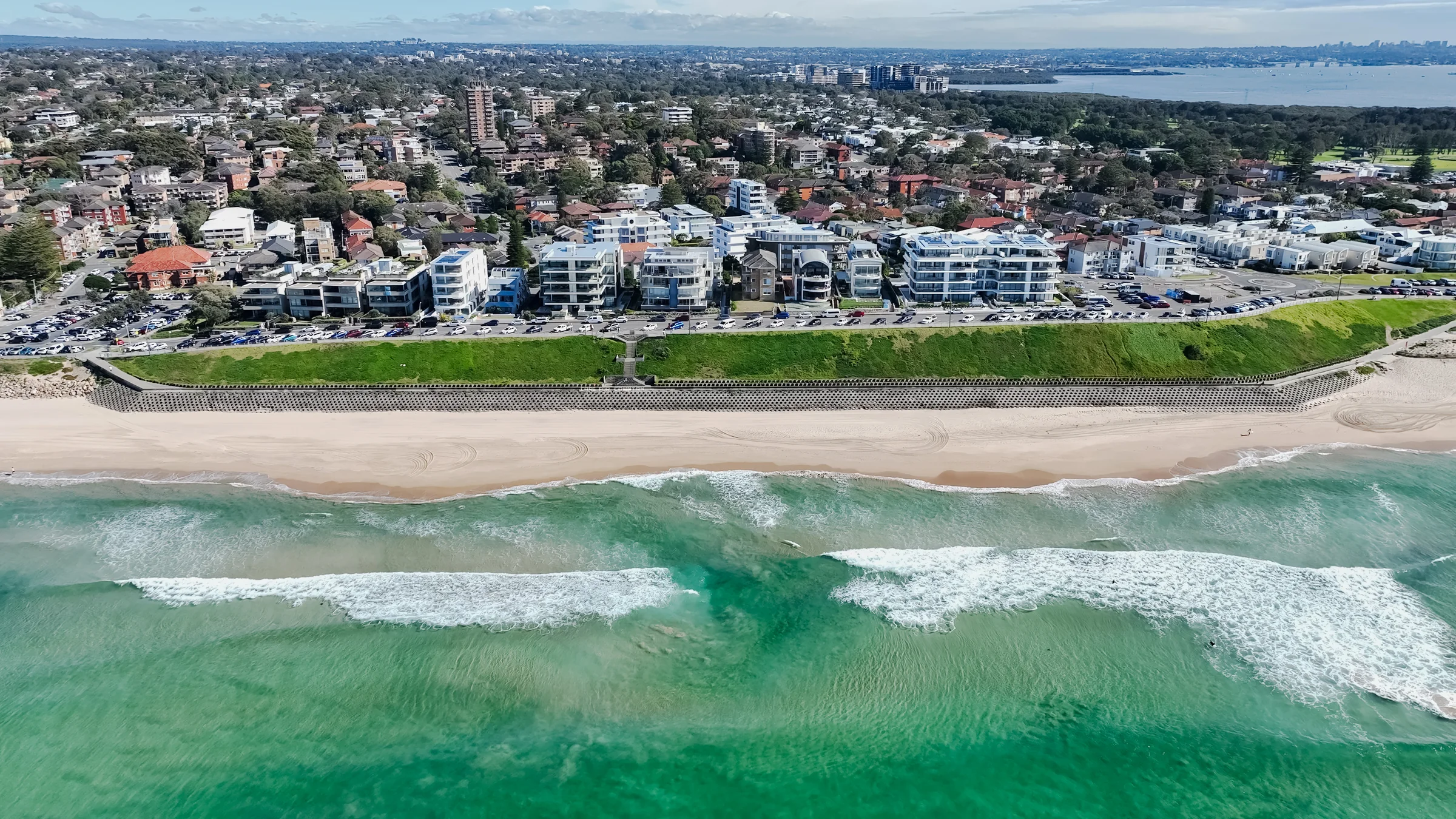 Wide aerial view of Elouera Beach and the coastline stretching south