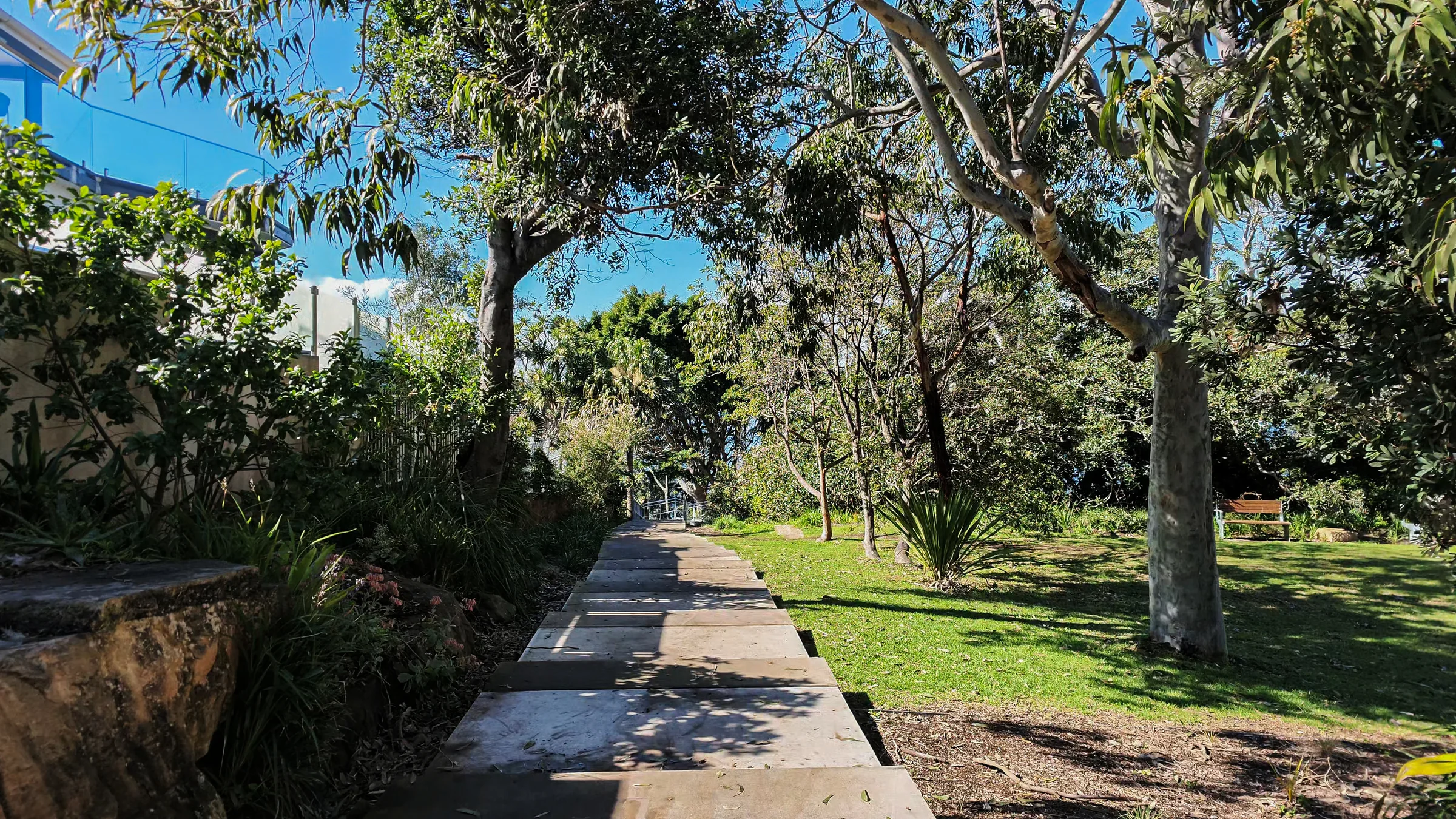 Stone path through the grass and trees at Hungry Point Reserve