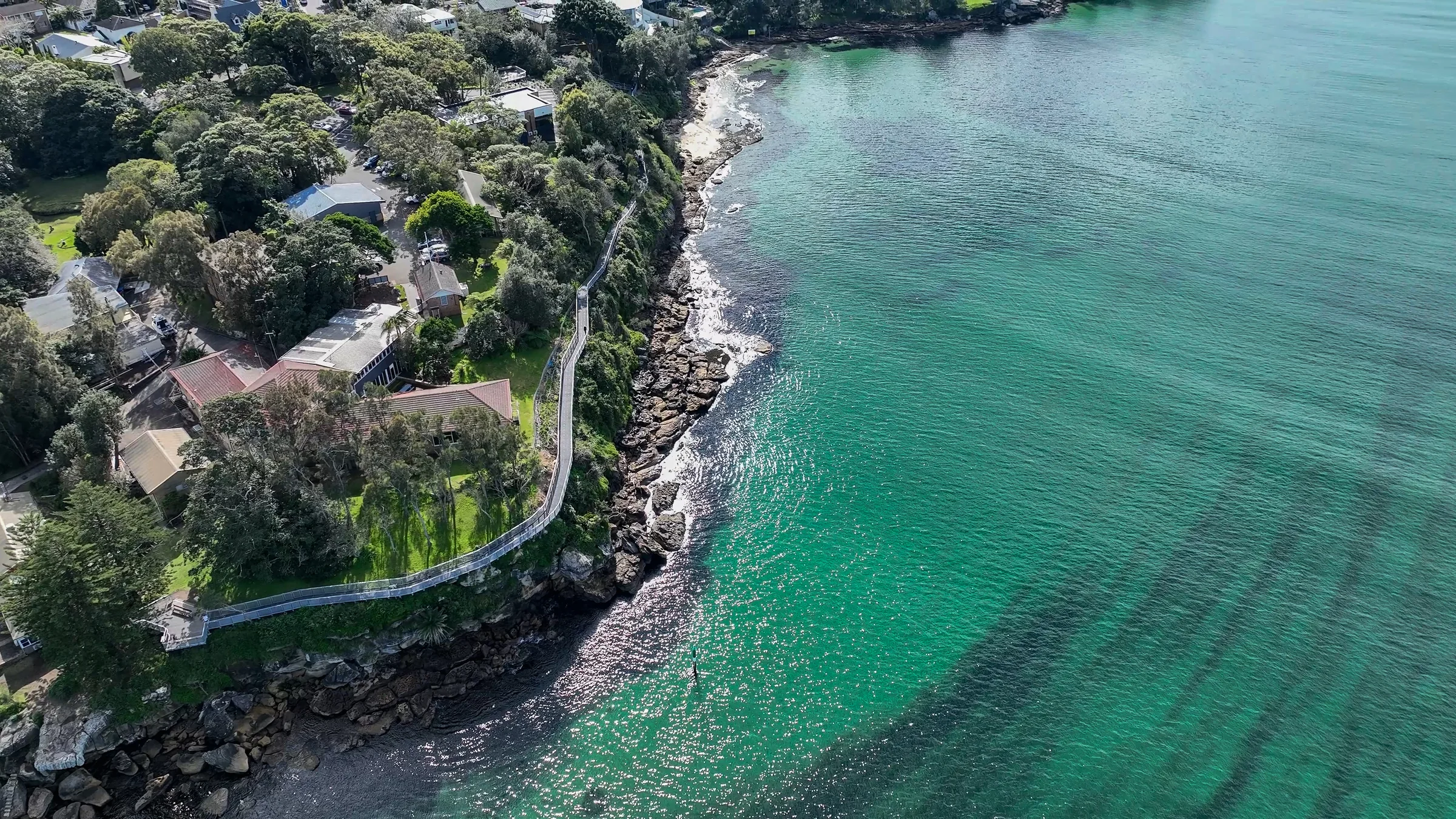 Aerial view of the tree-covered Hungry Point headland and shoreline