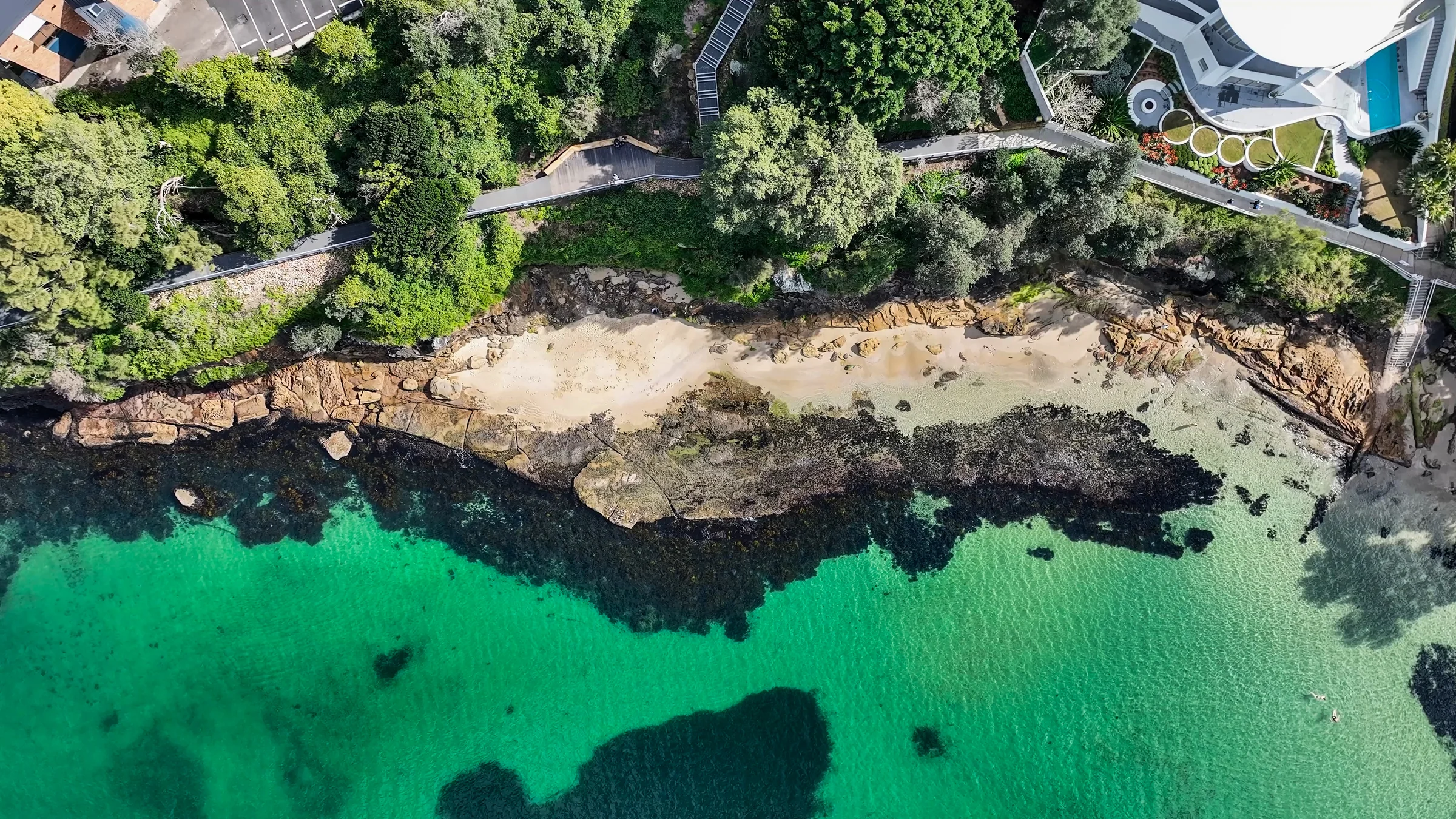 Overhead view of Salmon Haul Bay with sandstone shoreline and clear green water