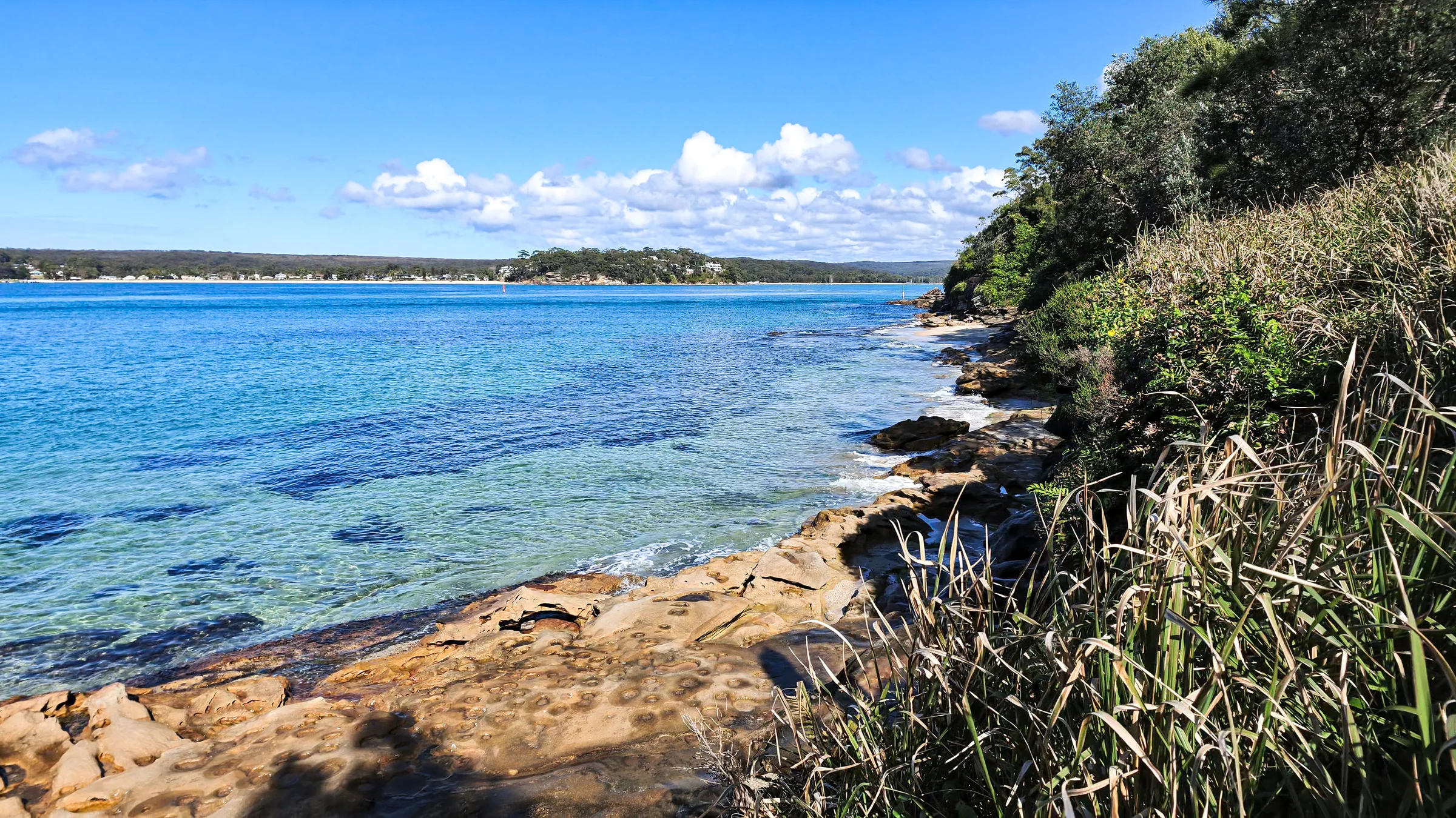 Sandstone rocks and clear water below the coastal path at Salmon Haul