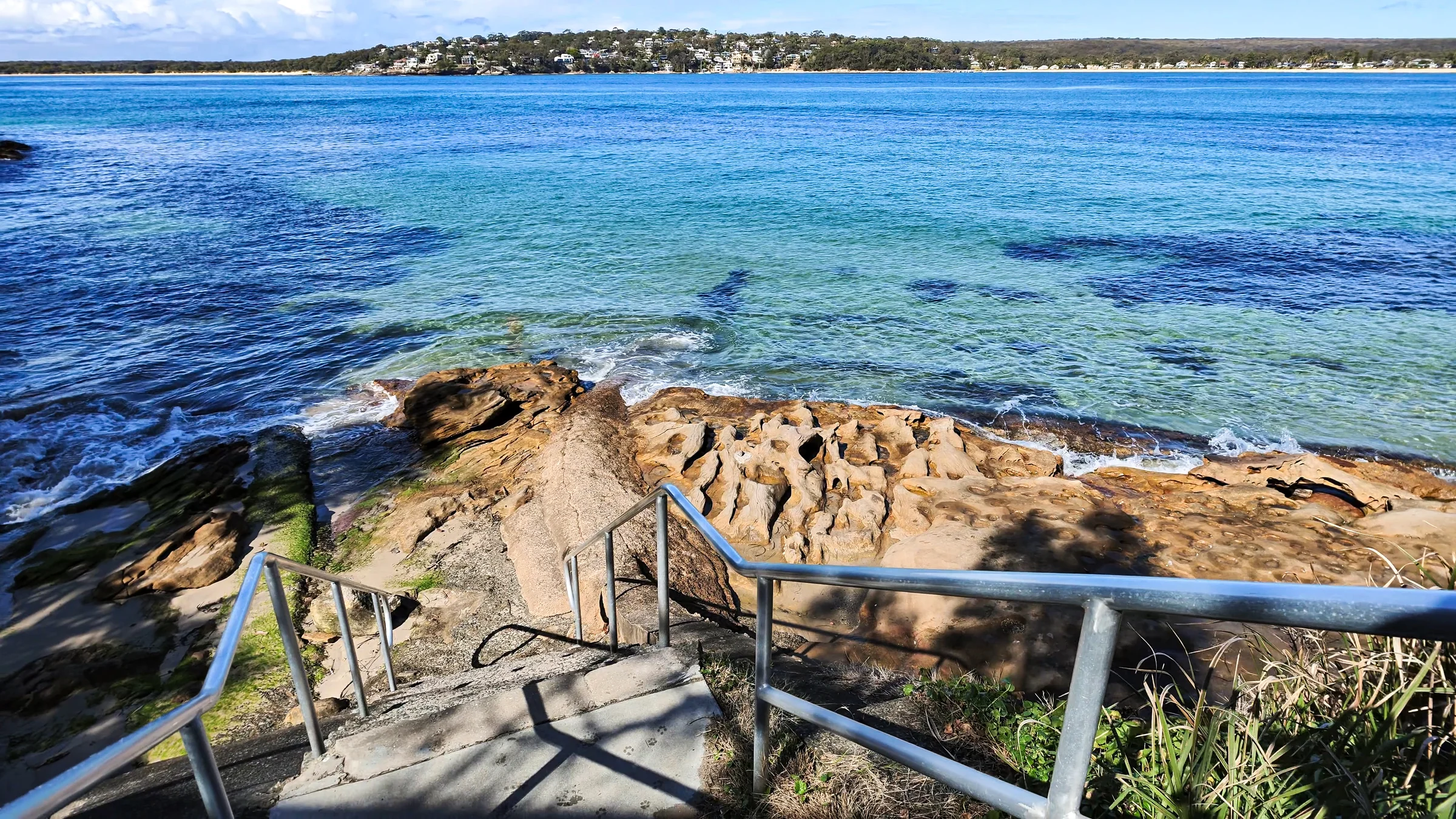 Stairs and handrails leading down to sandstone rocks beside Salmon Haul Bay