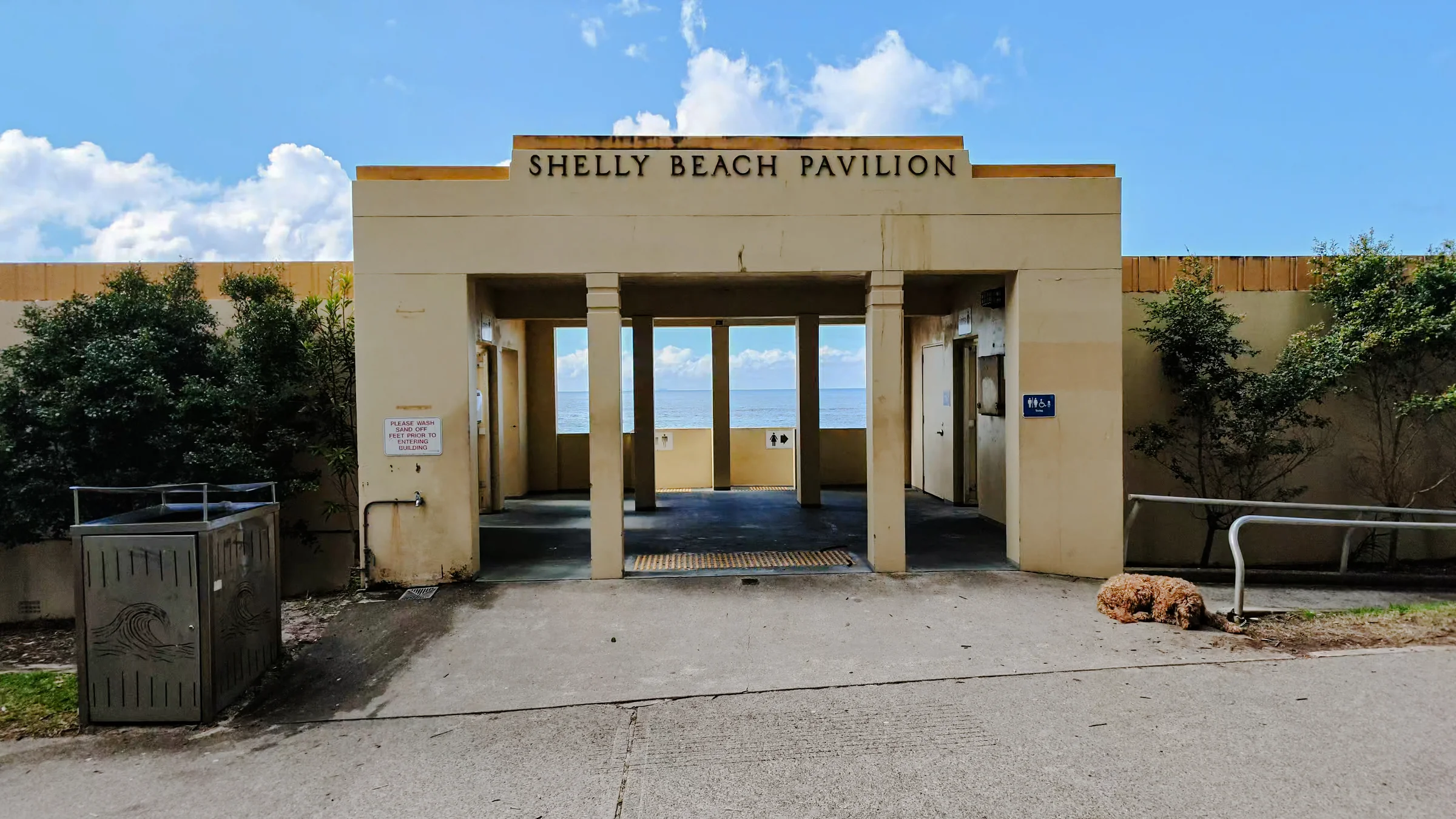 Entrance to Shelly Beach Pavilion with blue sea visible through the doorway