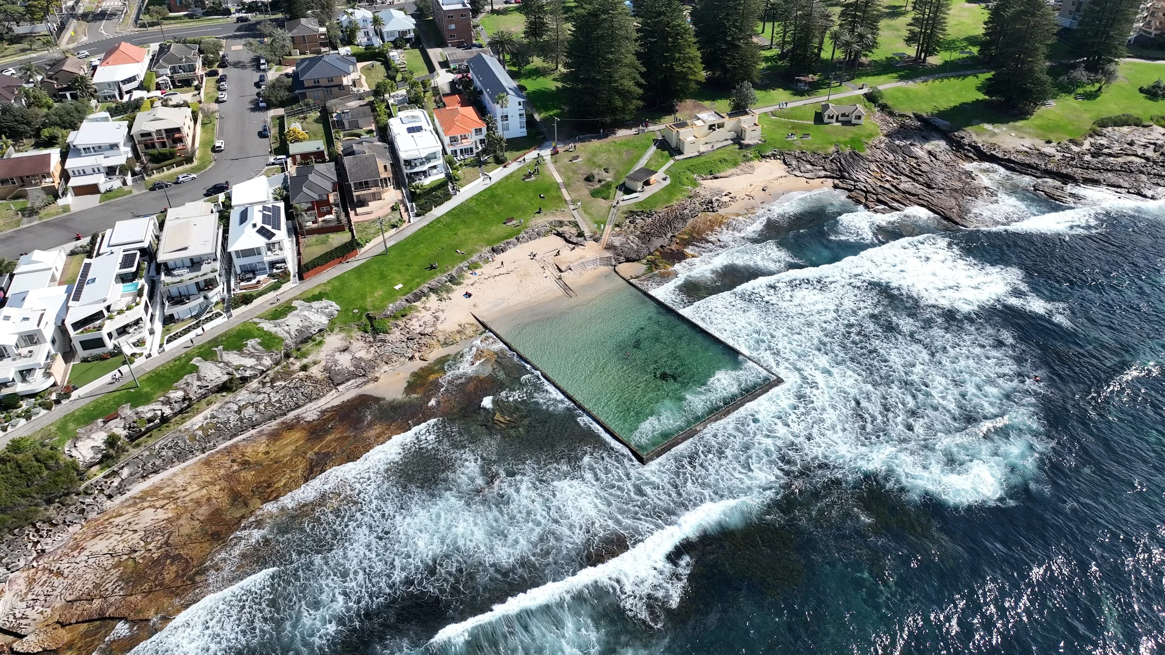 Aerial view of Shelly Beach ocean pool, sandy beach and green park