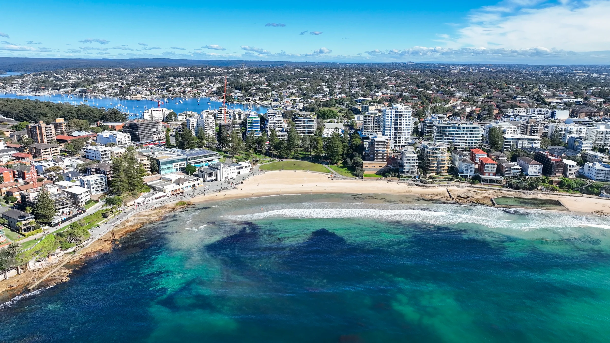 Aerial view of South Cronulla Beach and the town with Gunnamatta Bay behind