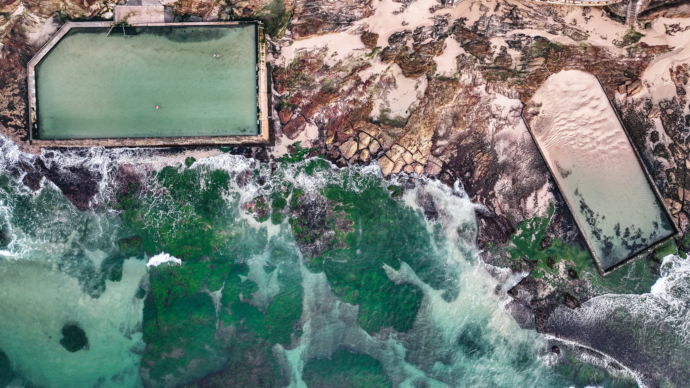Both Cronulla ocean pools on the rock platform seen directly from above