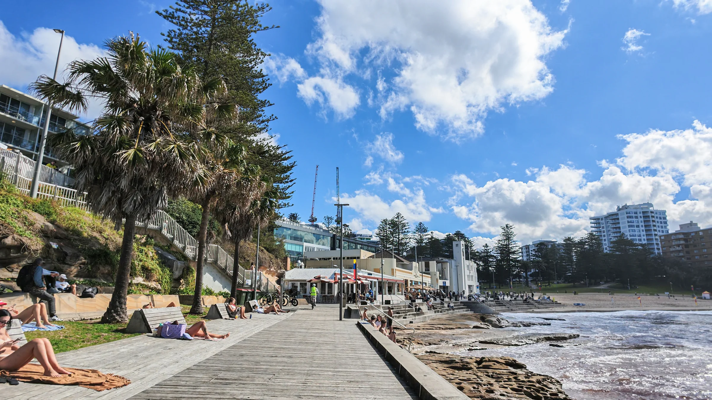 People relaxing beside the Esplanade walkway near South Cronulla Beach