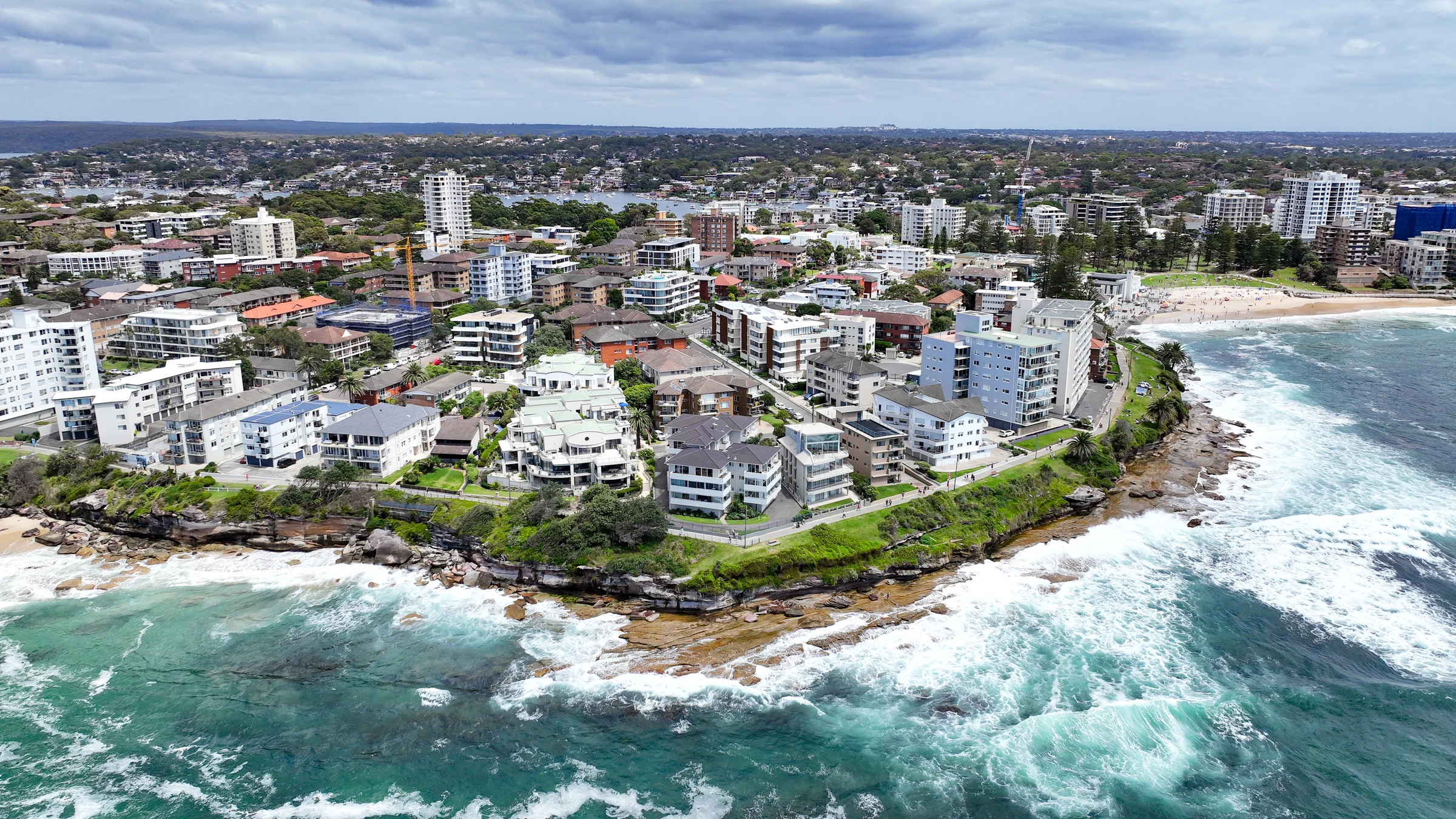 Aerial view of white surf around the Cronulla peninsula with South Cronulla Beach beyond