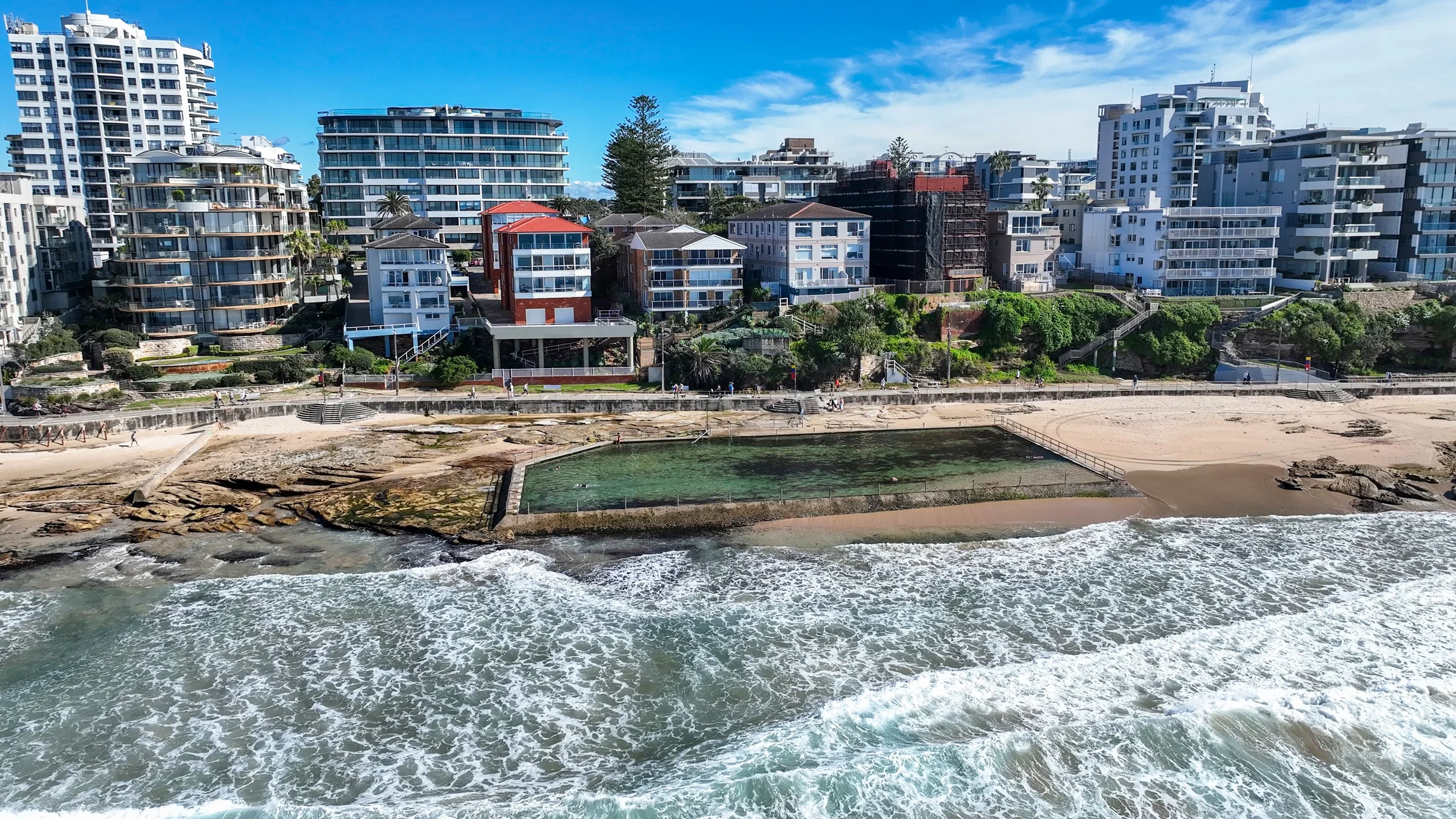 Cronulla ocean pool on the rock platform with white surf in front
