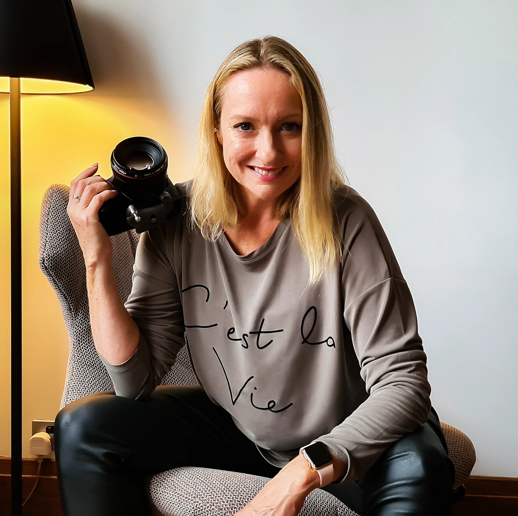 Susan White seated with her camera